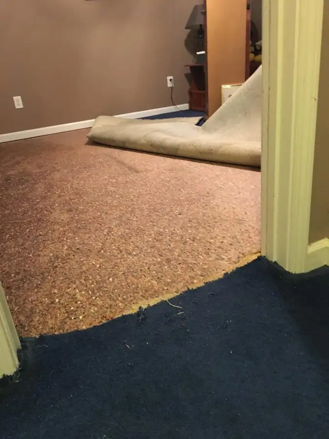 Carpet pad removal revealing water damage during Water Mitigation Services in Moses Lake